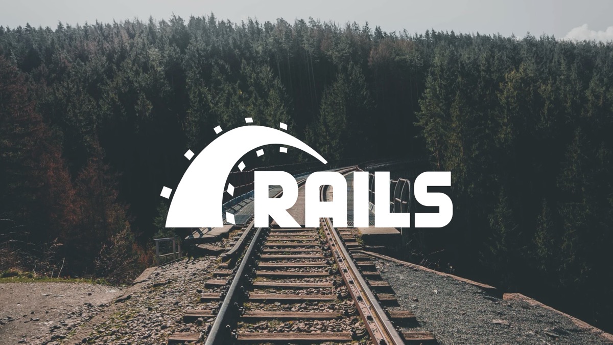 Several people sitting around a table with laptops and notebooks on it.